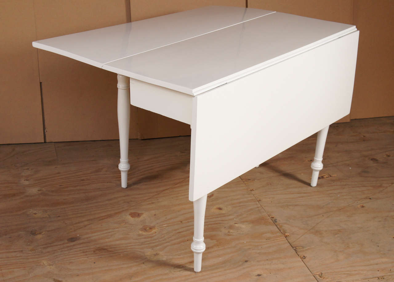 white lacquered cherry, drop leaf table with ring turned legs and peg feet. newly lacquered.